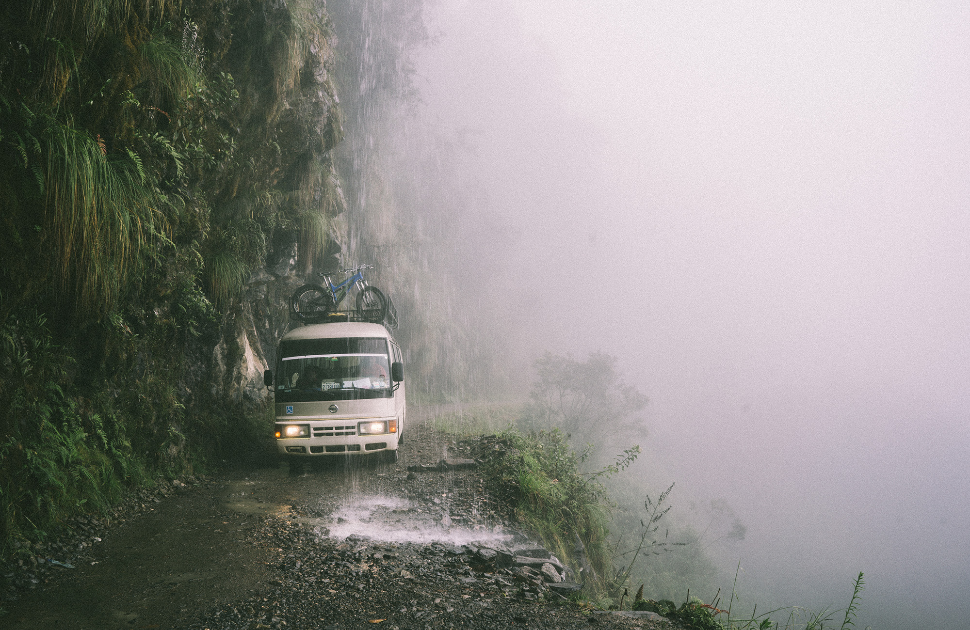 death-road-north-yungas-road-bolivia-white-van-heavy-rainfall-cover