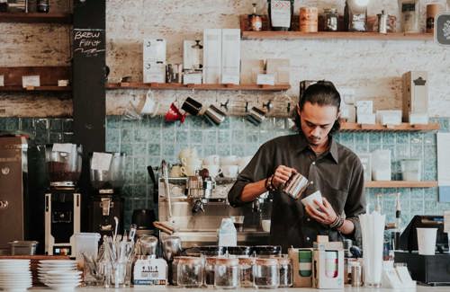 Man making coffee working abroad | KILROY