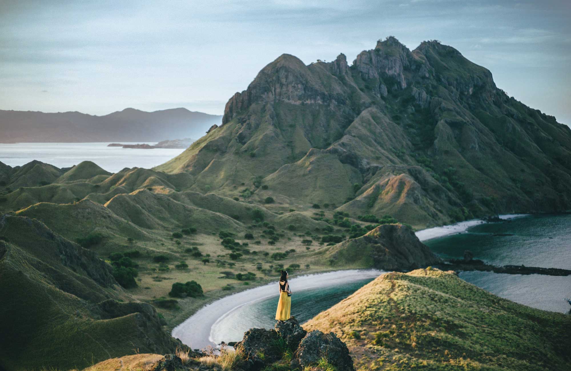 indonesia-padar-girl-standing-mountain-yellow-dress