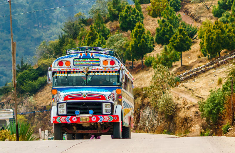 Image of a colourful bus on a road in Latin America - KILROY
