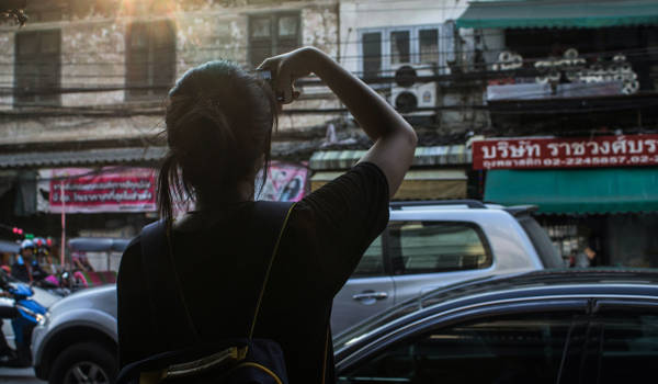 Woman Alone In Bangkok On A Busy Street